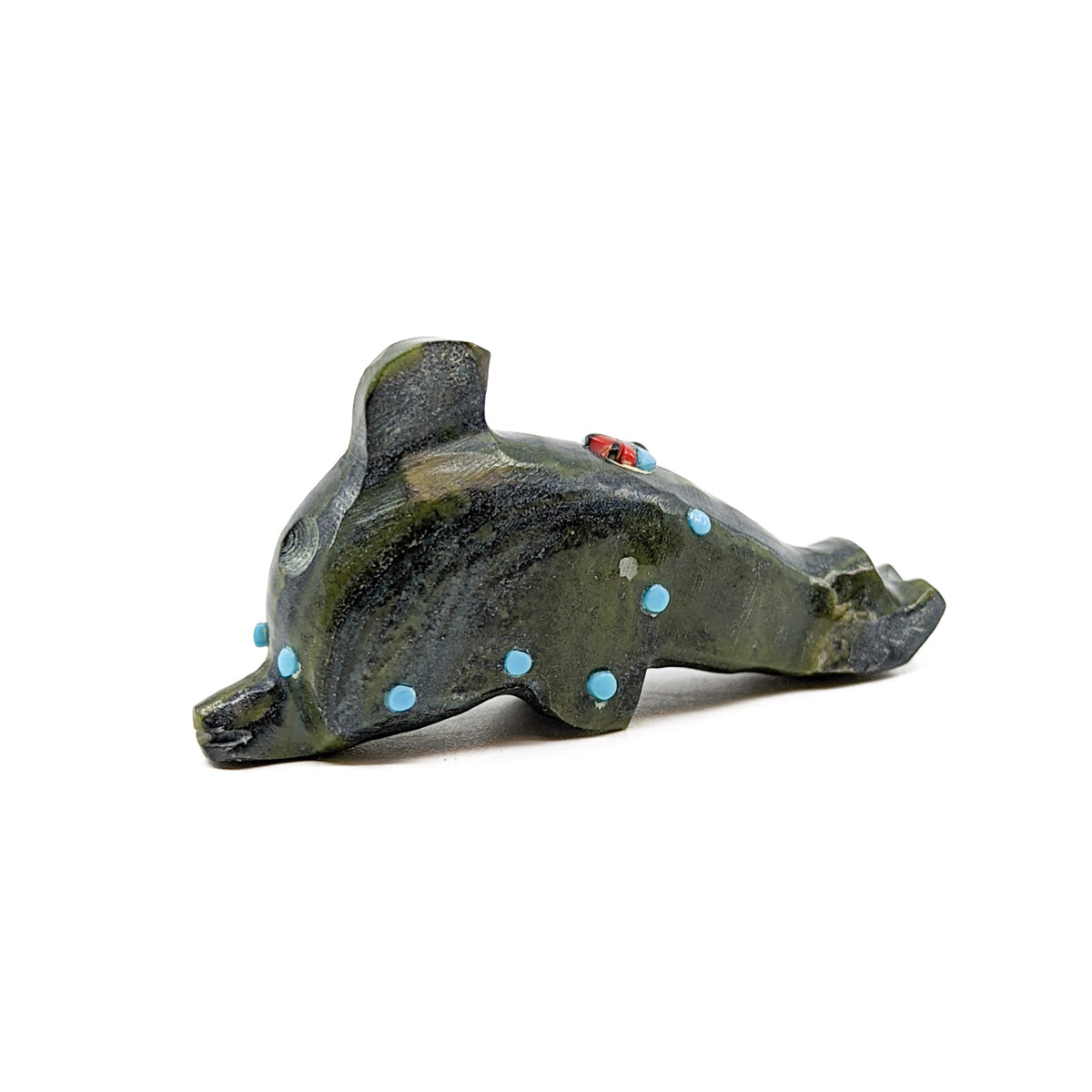 Serpentine Dolphin with Turquoise eyes and accents, adorned with a Jet, Turquoise, and Red Coral Zuni Sun Face  Measures approximately 2.25 inches long x .5 inches wide x 1.25 inches high