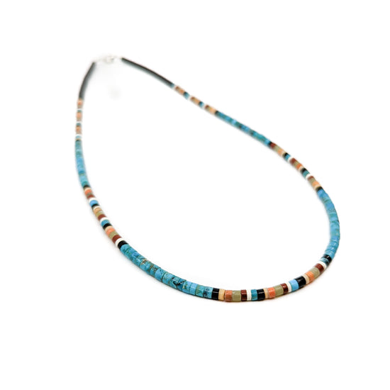 Handmade heishi bead necklace by jeweler Dorene Calabeza, from Kewa Pueblo (formerly Santo Domingo Pueblo) in New Mexico Measures 18 inches long, has sterling silver hook and eye clasp Beads are made from assorted semi-precious stones and materials such as&nbsp; Jet, Pipestone, Turquoise and Shell, combinations may vary.