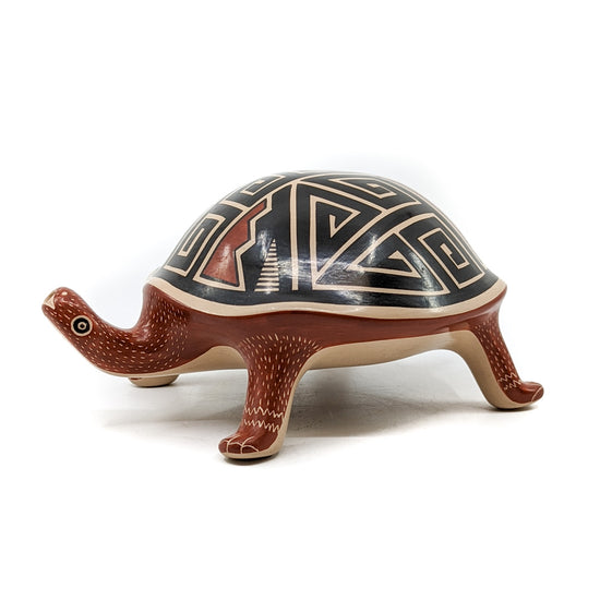 Handcrafted pot by Mata Ortiz artist, Jorge Corona&nbsp; Measures approximately inches 3.5 high x 8 inches long from head to tail x 5.5 inches in diameter  Polychrome turtle figure with a geometric design