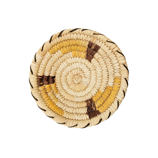 This nicely handwoven polychrome basket is from circa 1980, weaver unknown, and measures approximately 4.5 inches in diameter and .75 inches deep. Coils measure approx.&nbsp; .25 inches wide.  Plant materials are hand gathered from the Sonoran Desert for basket weaving. The interior coils are native Beargrass and the white, closed stitches surrounding the coils are sun bleached Soaptree Yucca. The green stitching is unbleached Soaptree Yucca, and the dark red material used in the design is rare Yucca Root. 