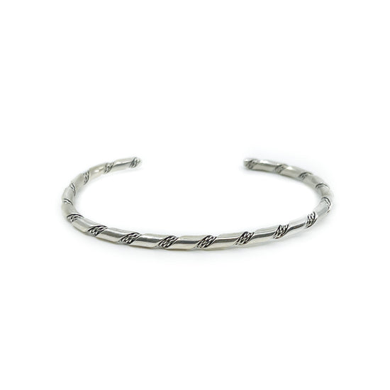 Sterling silver bracelet, classic design, great for stacking! Flattened wire intertwined with twist, by Elaine Tahe Lightly flexible, has some give Measures 5.5 inches plus a 1.5 inch opening - appropriate for a 6.5 to 7.5 inch wrist