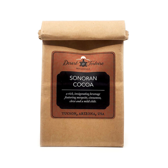 Sonoran Cocoa with Mesquite Meal &amp; Santa Cruz Mild Chile.&nbsp;
Made with local velvet mesquite meal, this traditional beverage (known as&nbsp;Champurro de Péchitas) is uniquely sweetened by the natural tang of velvet mesquite flour (wildharvested&nbsp;in Tucson, AZ).
The chile (locally grown in the Santa Cruz River Valley) is very mild with no heat, but adds a hint of flavor.&nbsp;

Ingredients: Cacao, Velvet Mesquite Flour, Santa Cruz Mild Chile, Cinnamon, Clove, Himalayan Pink Salt

Add 1 Tablespoon 